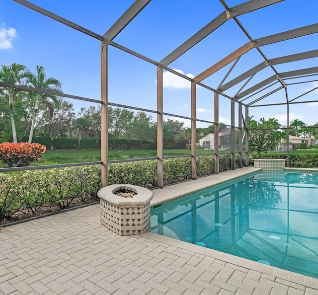 view of swimming pool with glass enclosure and a patio area