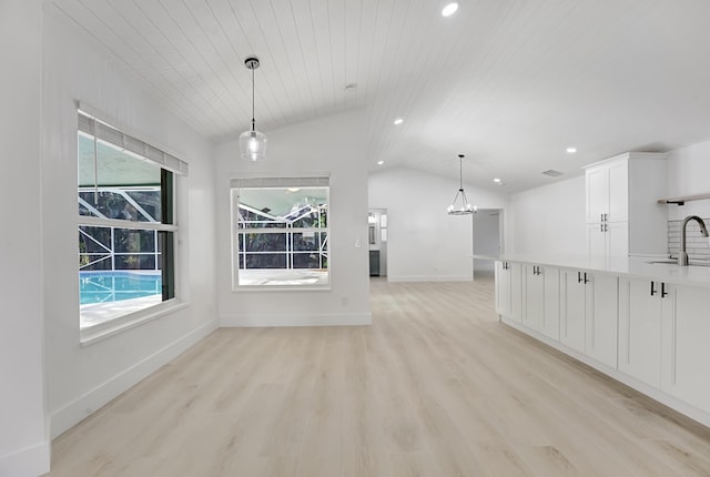 unfurnished living room with wood ceiling, sink, light hardwood / wood-style floors, and lofted ceiling