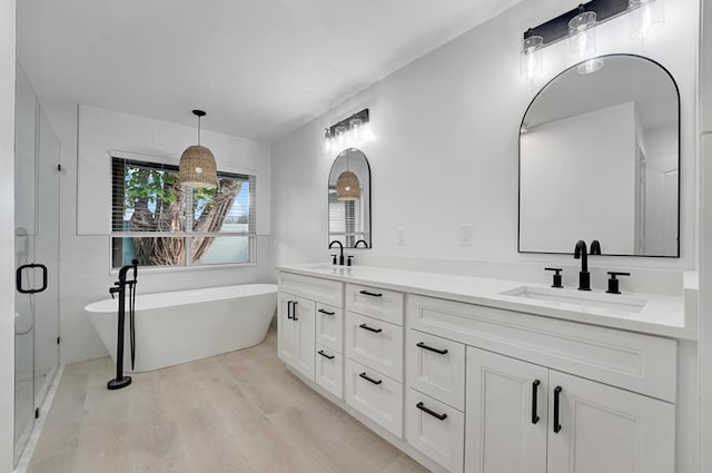 bathroom featuring separate shower and tub, vanity, and hardwood / wood-style flooring