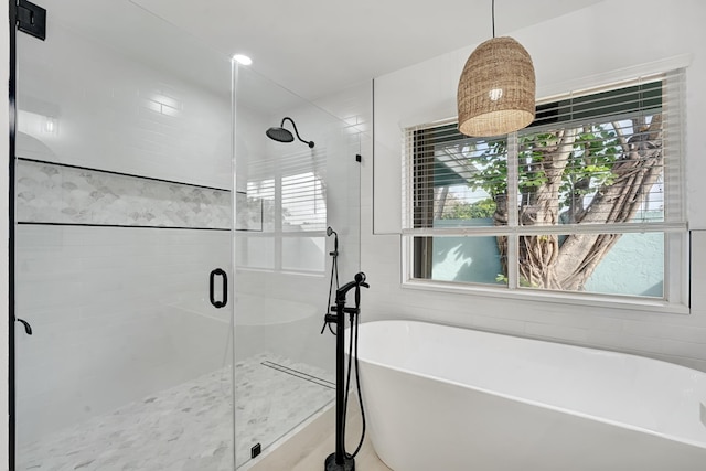 bathroom with separate shower and tub