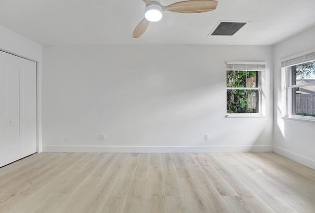 empty room with ceiling fan and light wood-type flooring