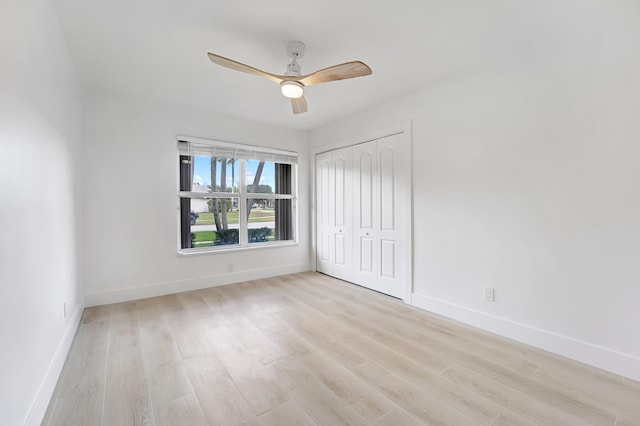 unfurnished bedroom with ceiling fan, a closet, and light hardwood / wood-style flooring