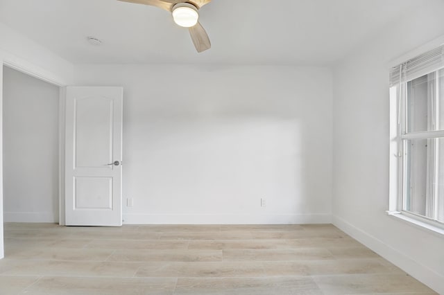 empty room with light wood-type flooring and ceiling fan