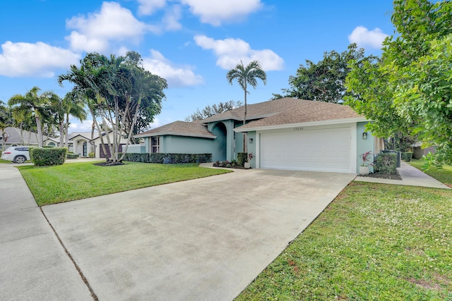 ranch-style house featuring a front lawn and a garage