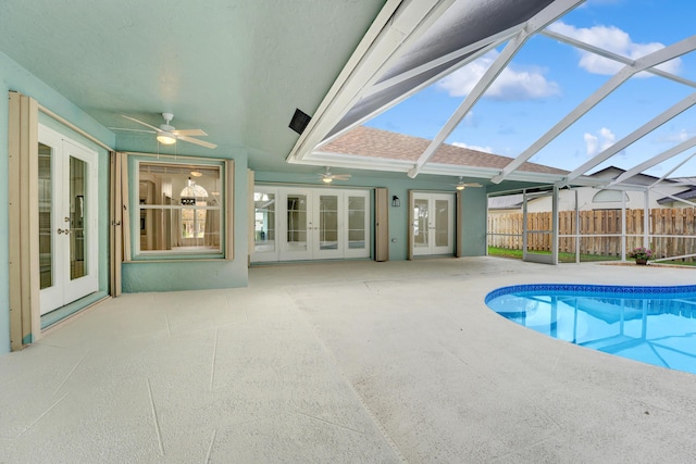 view of pool featuring ceiling fan and french doors