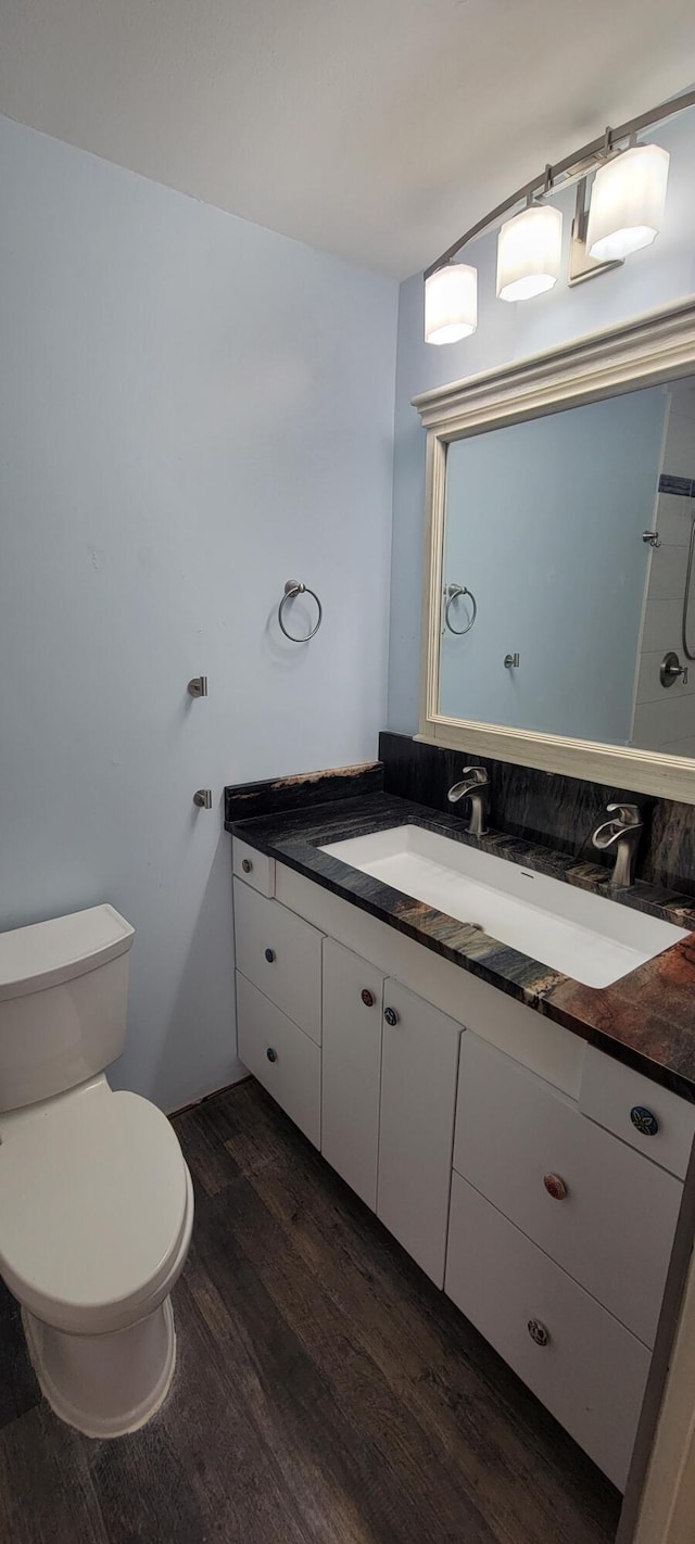 bathroom featuring vanity, hardwood / wood-style floors, and toilet