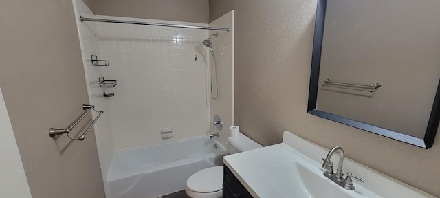 full bathroom featuring tiled shower / bath, vanity, and toilet