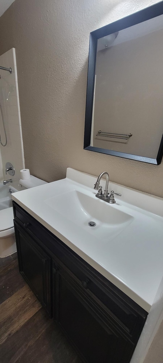 full bathroom with vanity, hardwood / wood-style floors, toilet, and shower / bath combination