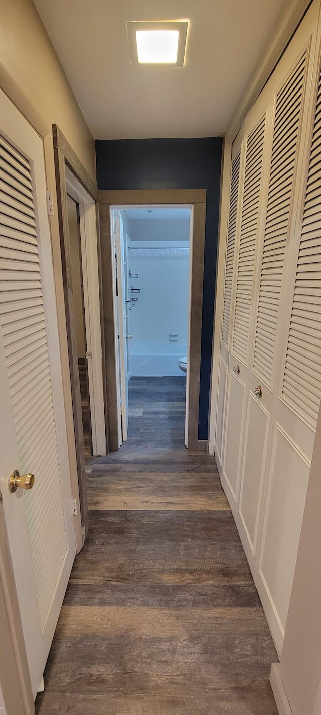 hallway with dark wood-type flooring