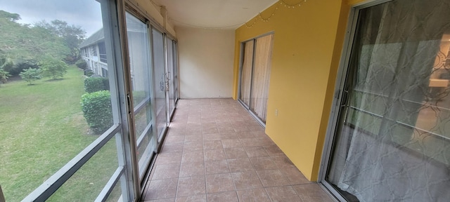 unfurnished sunroom featuring light tile patterned flooring