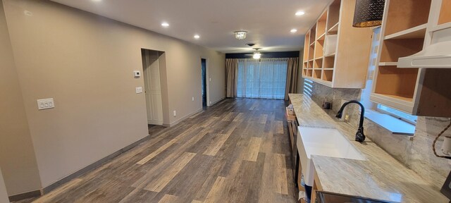 kitchen with hardwood / wood-style flooring, plenty of natural light, ceiling fan, and sink