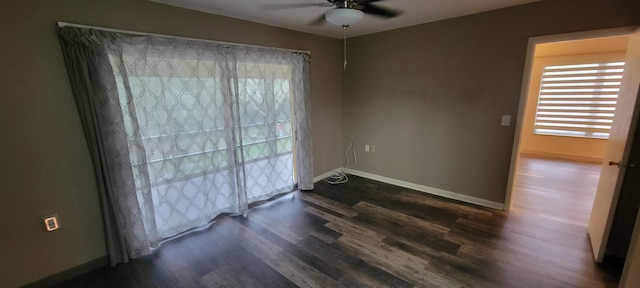 spare room featuring ceiling fan and dark hardwood / wood-style flooring