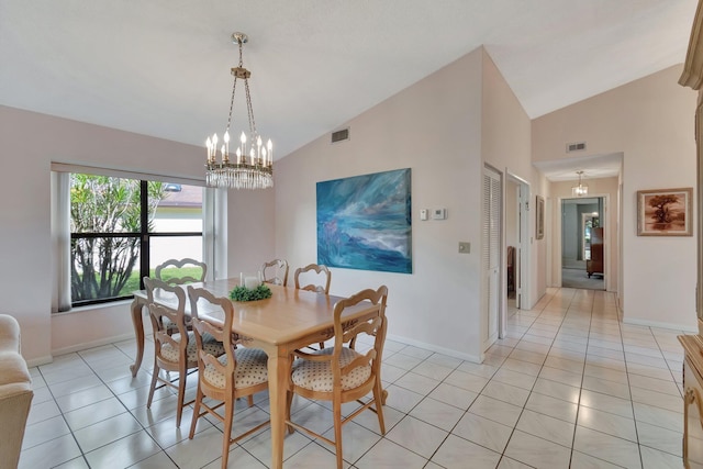 dining room with light tile patterned floors, vaulted ceiling, and a notable chandelier