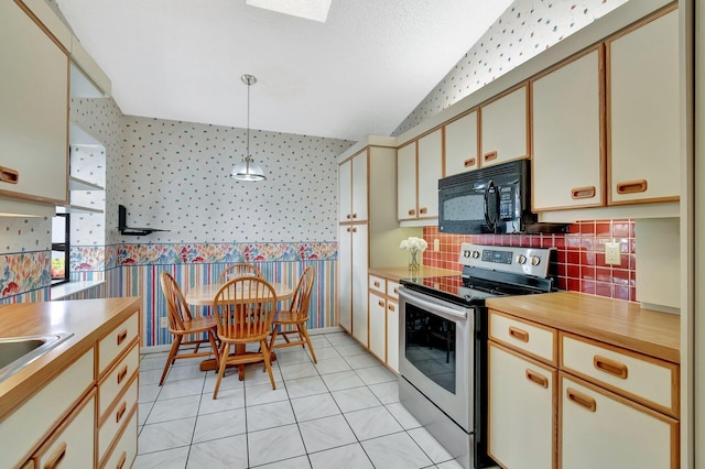 kitchen with hanging light fixtures, light tile patterned floors, tasteful backsplash, cream cabinets, and stainless steel range with electric cooktop