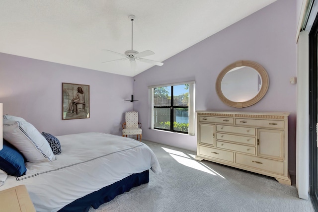 bedroom with ceiling fan, light carpet, and lofted ceiling