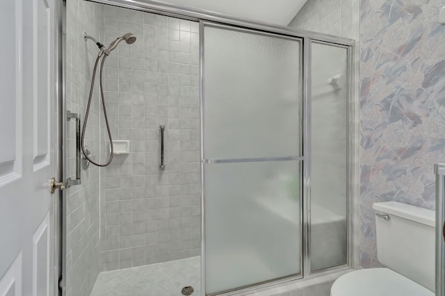 bathroom with an enclosed shower and toilet