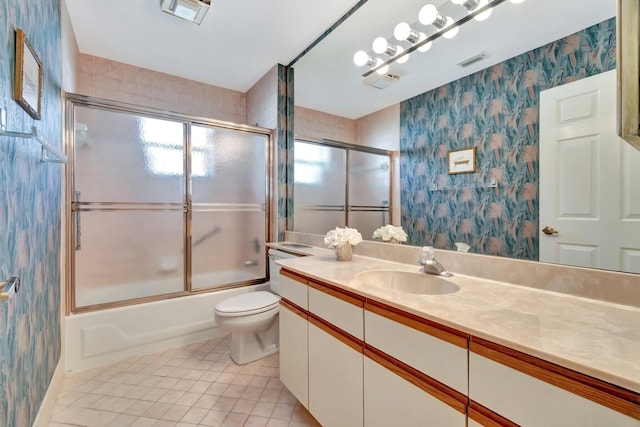 full bathroom with tile patterned flooring, vanity, toilet, and enclosed tub / shower combo