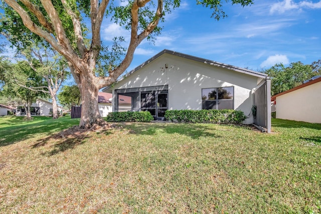 back of property featuring a lawn