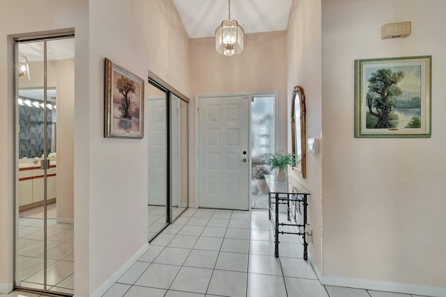 entryway featuring light tile patterned floors and an inviting chandelier