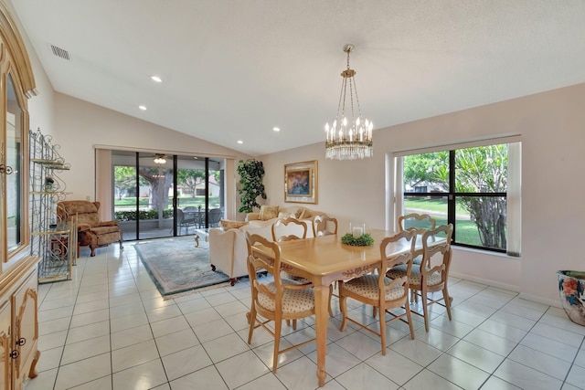 dining room with light tile patterned floors, a chandelier, and vaulted ceiling