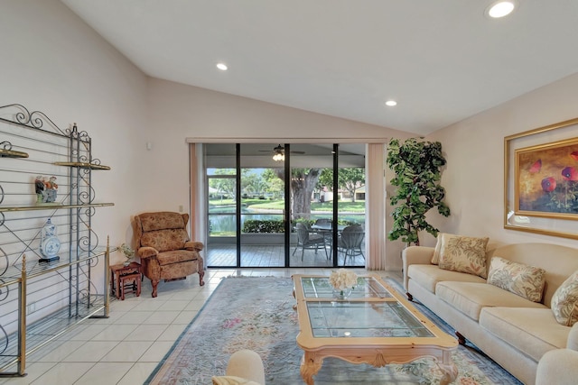 living room with vaulted ceiling, ceiling fan, and light tile patterned flooring