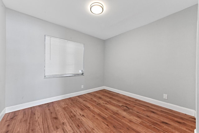 empty room with hardwood / wood-style flooring