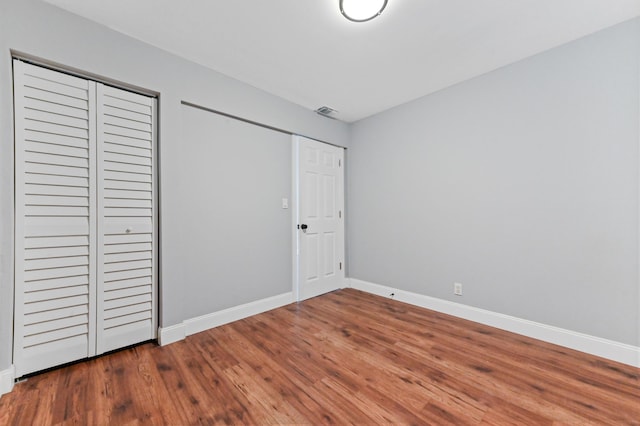 unfurnished bedroom featuring hardwood / wood-style flooring