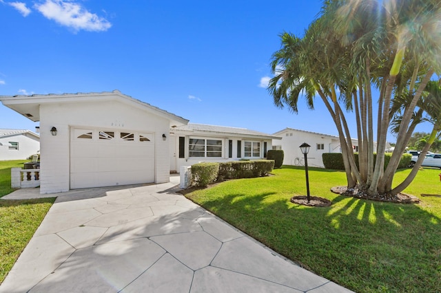 ranch-style house featuring a front yard and a garage