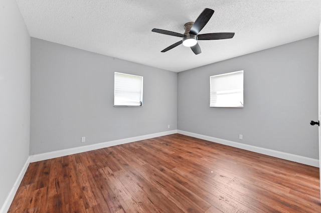 empty room featuring hardwood / wood-style floors, ceiling fan, and a textured ceiling