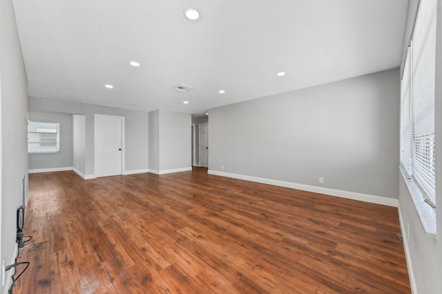 unfurnished room featuring dark hardwood / wood-style flooring and a healthy amount of sunlight