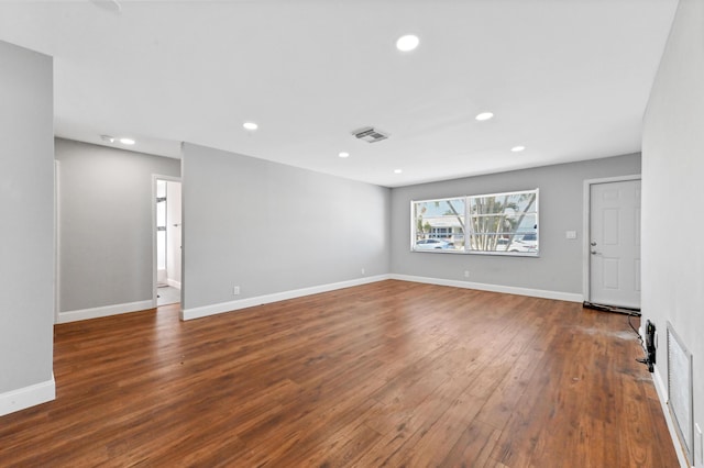 unfurnished room with dark wood-type flooring