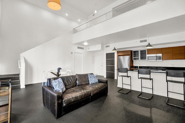 living room featuring a towering ceiling