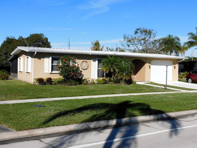 ranch-style home with a garage and a front lawn