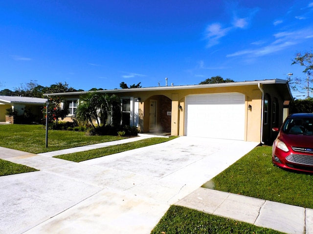 single story home featuring a front lawn and a garage