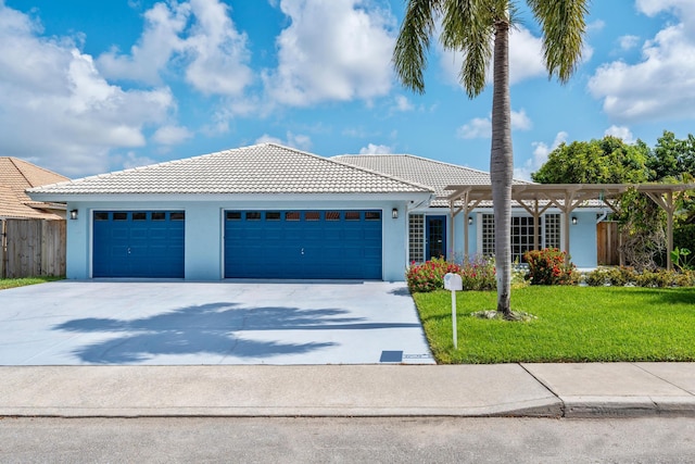 view of front of property featuring a front lawn and a garage