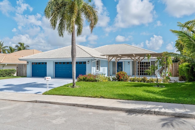 view of front of property featuring a front yard and a garage