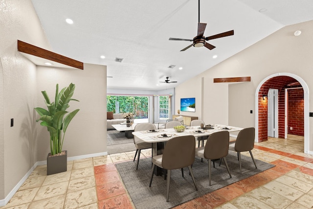 dining space with ceiling fan, high vaulted ceiling, and a textured ceiling