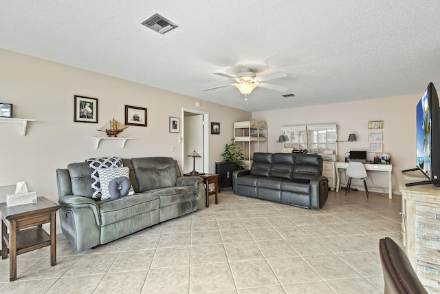 tiled living room featuring ceiling fan and a textured ceiling