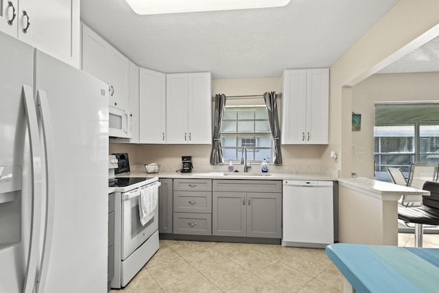 kitchen with gray cabinetry, sink, a textured ceiling, white appliances, and white cabinets