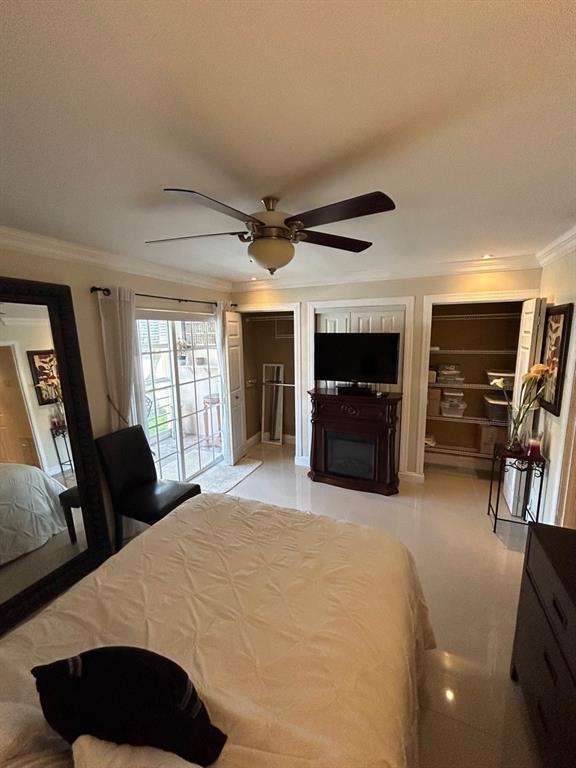 bedroom with ceiling fan and crown molding