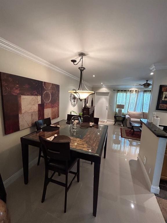 tiled dining room with ceiling fan and ornamental molding