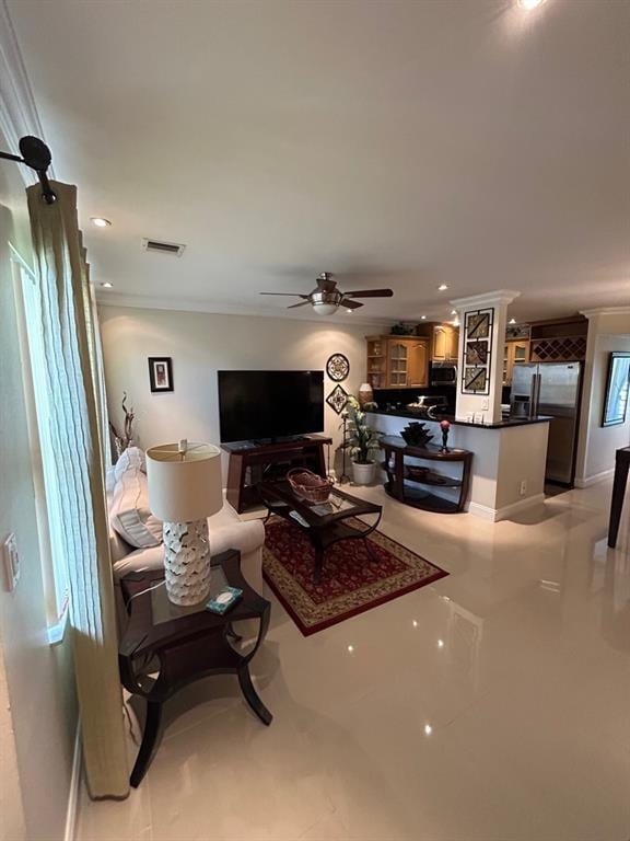 living room with ceiling fan and crown molding