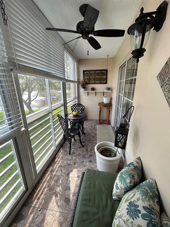 sunroom featuring ceiling fan and a healthy amount of sunlight