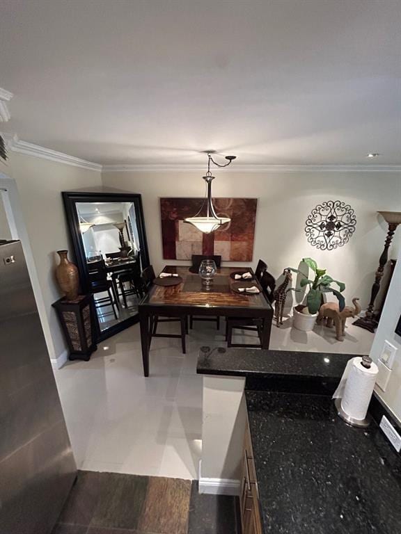 dining room featuring wood-type flooring and crown molding