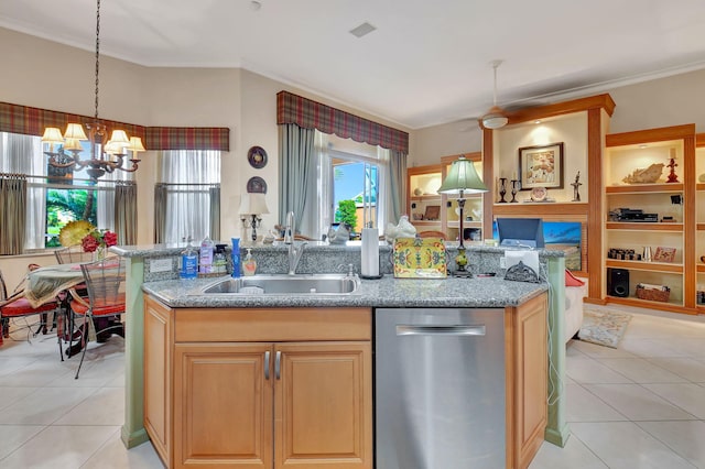 kitchen with dishwasher, light tile patterned floors, sink, and decorative light fixtures