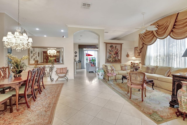 living room featuring ceiling fan with notable chandelier, light tile patterned flooring, and crown molding