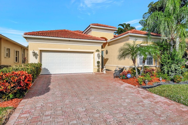 mediterranean / spanish home featuring a garage