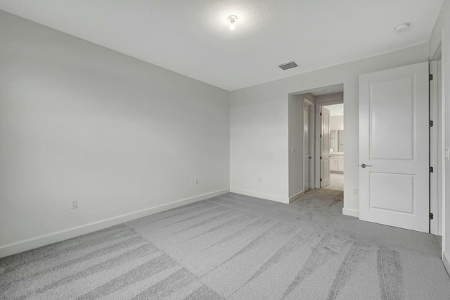 spare room with light carpet