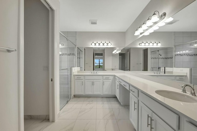 bathroom featuring vanity and a shower with door