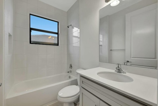 full bathroom with toilet, vanity, and tiled shower / bath